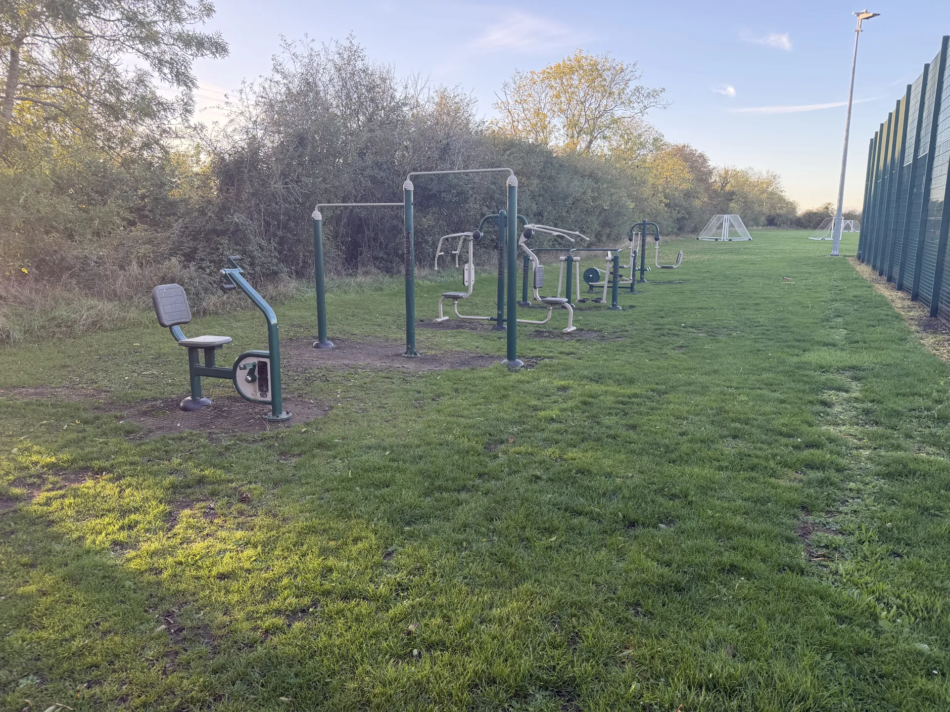 The row of outdoor gym stations along the field
